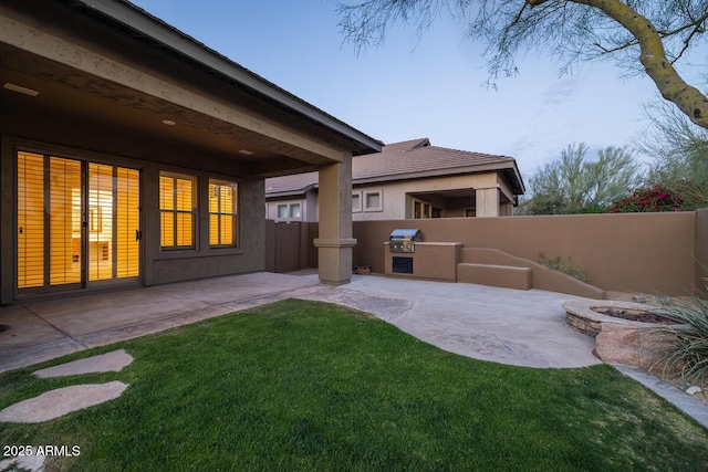 view of yard with a patio area, a fire pit, and fence