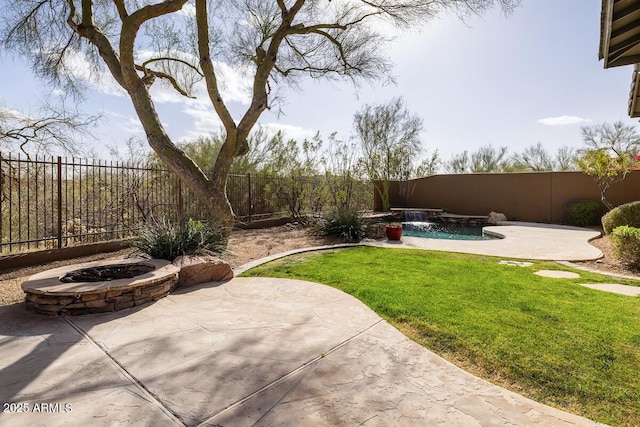 view of yard with a patio area, a fire pit, a fenced in pool, and a fenced backyard