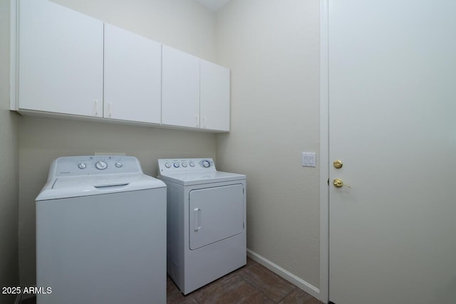 laundry room with cabinet space, separate washer and dryer, and baseboards