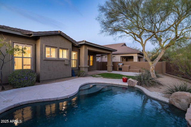 view of swimming pool featuring a patio, fence, and a fenced in pool