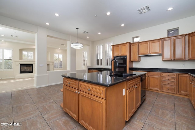 kitchen with recessed lighting, visible vents, and brown cabinets