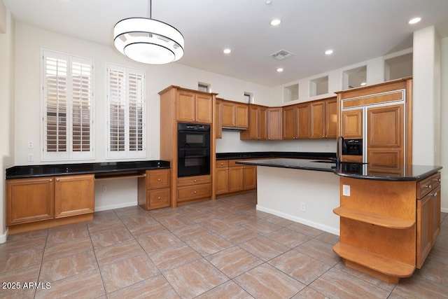 kitchen featuring brown cabinetry, a center island with sink, open shelves, dobule oven black, and dark countertops