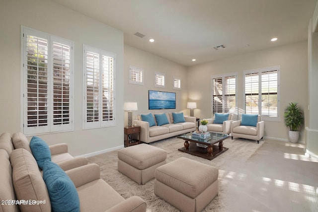 carpeted living room with recessed lighting, visible vents, and baseboards