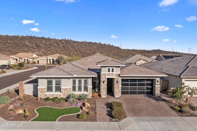 view of front of house with a garage and a mountain view