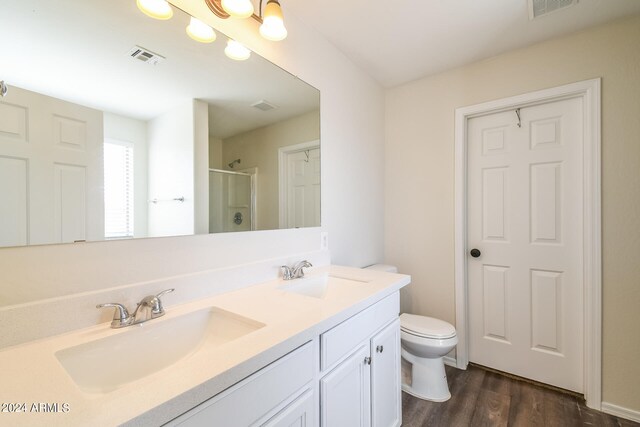 bathroom with a shower with door, toilet, hardwood / wood-style flooring, and vanity