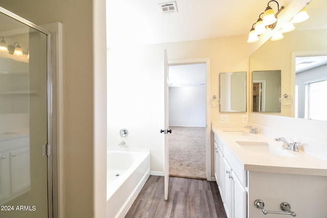 bathroom with vanity, shower with separate bathtub, and wood-type flooring