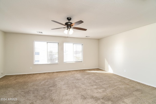 empty room with ceiling fan and carpet