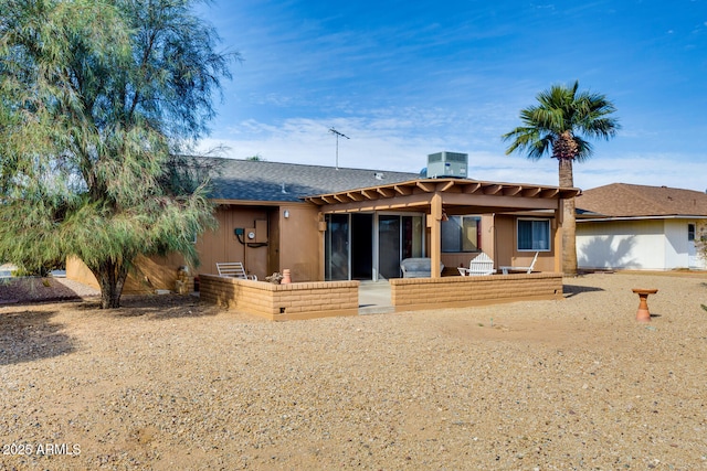 rear view of property featuring central AC unit