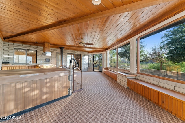 27610 W Gill Rd, Morristown, AZ 85342 - unfurnished sunroom with wood ceiling, carpet floors, and brick wall