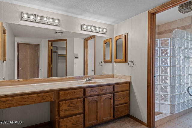27610 W Gill Rd, Morristown, AZ 85342 - full bath featuring a walk in shower, vanity, and a textured ceiling