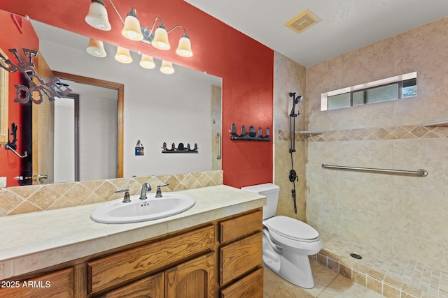27610 W Gill Rd, Morristown, AZ 85342 - bathroom featuring toilet, vanity, a tile shower, and tile patterned flooring