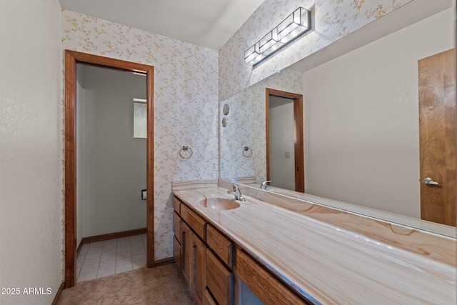 27610 W Gill Rd, Morristown, AZ 85342 - bathroom with vanity, wallpapered walls, tile patterned floors, and baseboards