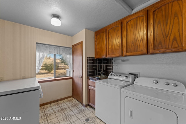 27610 W Gill Rd, Morristown, AZ 85342 - laundry area with cabinet space, washing machine and dryer, baseboards, light flooring, and a textured ceiling