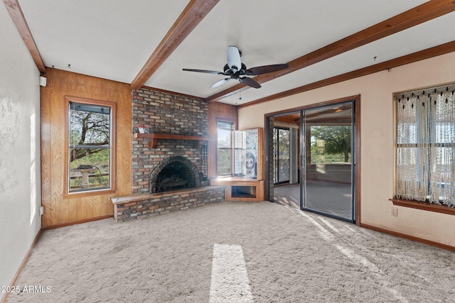 27610 W Gill Rd, Morristown, AZ 85342 - unfurnished living room with beam ceiling, baseboards, carpet flooring, a ceiling fan, and a fireplace