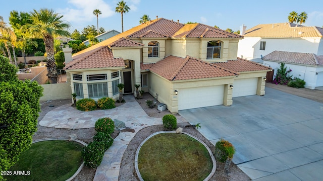 mediterranean / spanish-style home featuring a garage