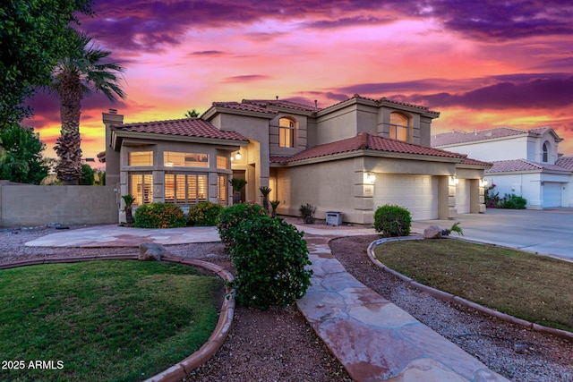 view of front of home featuring a garage and a yard