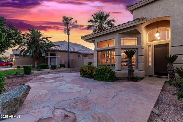 view of patio terrace at dusk