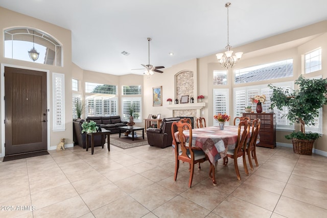 tiled dining area with ceiling fan with notable chandelier