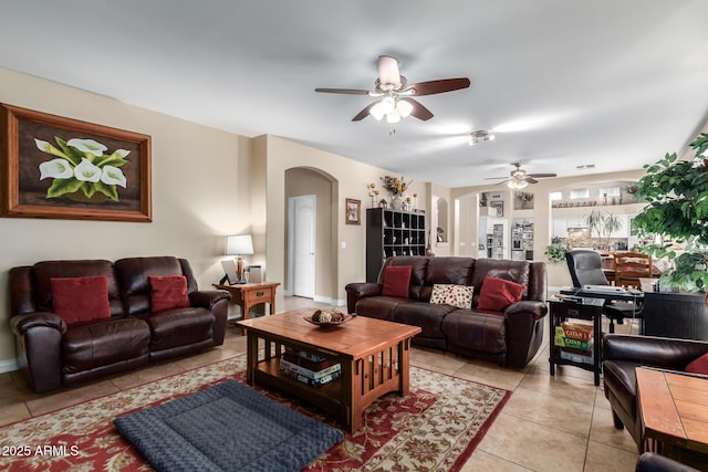 living room with ceiling fan and light tile patterned flooring