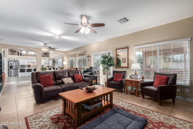 tiled living room with ceiling fan