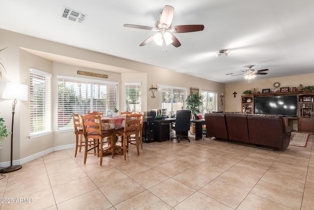 tiled dining room with ceiling fan and a healthy amount of sunlight