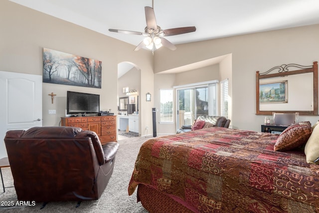 bedroom with ensuite bathroom, lofted ceiling, light carpet, and ceiling fan