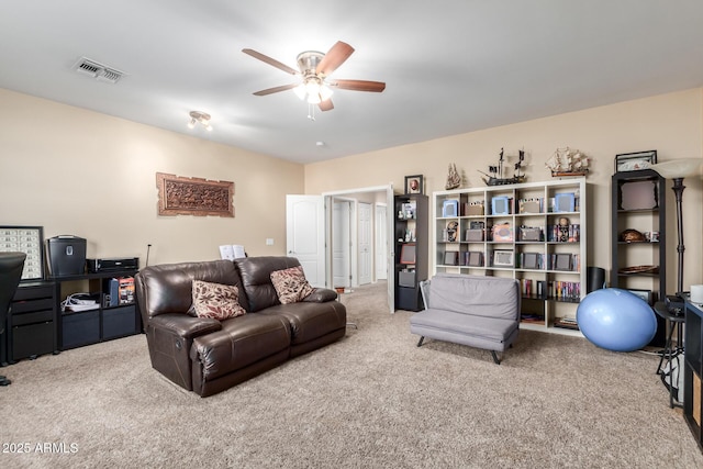 carpeted living room with ceiling fan