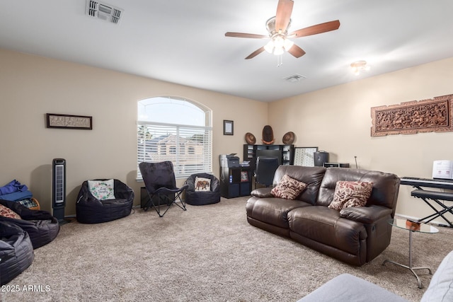 carpeted living room featuring ceiling fan