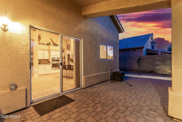 view of patio terrace at dusk