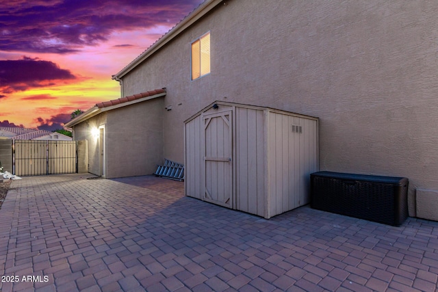 patio terrace at dusk with a storage unit