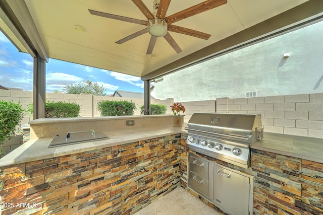 2087 N Park St, Buckeye, AZ 85396 - view of patio with area for grilling, grilling area, fence, and a ceiling fan