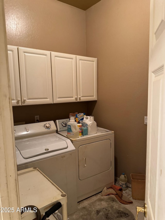 washroom with cabinets and independent washer and dryer