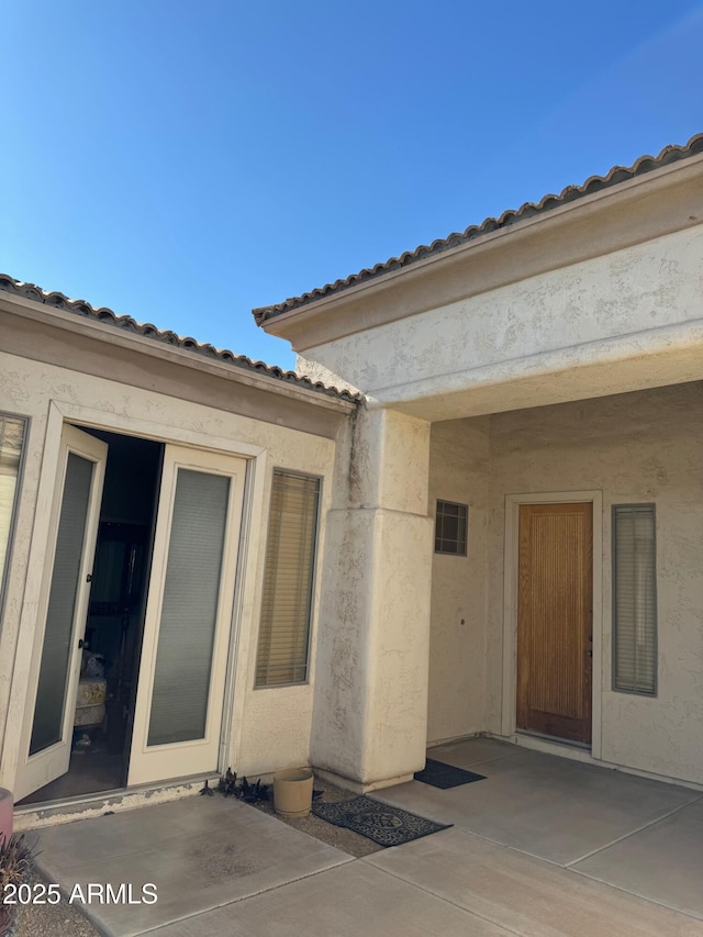 entrance to property with a patio