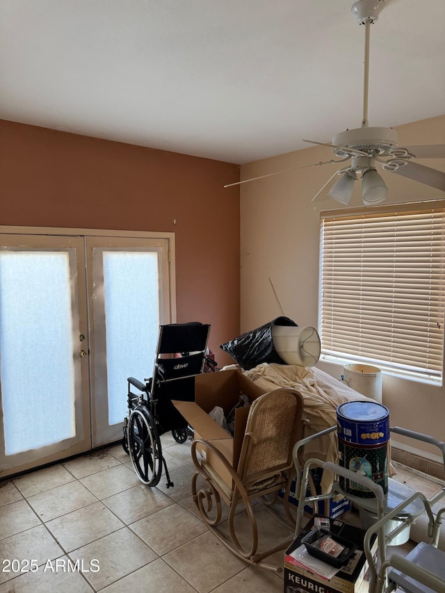 interior space featuring ceiling fan, light tile patterned flooring, and french doors