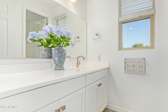 bathroom with a wealth of natural light, baseboards, and vanity