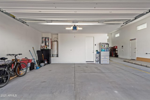 garage featuring a garage door opener and water heater