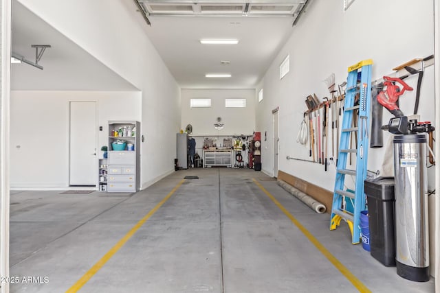 parking garage featuring baseboards and a workshop area