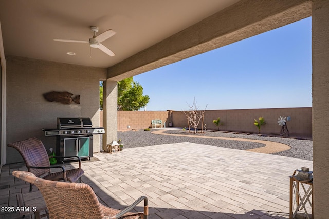 view of patio with a fenced backyard, a grill, and ceiling fan