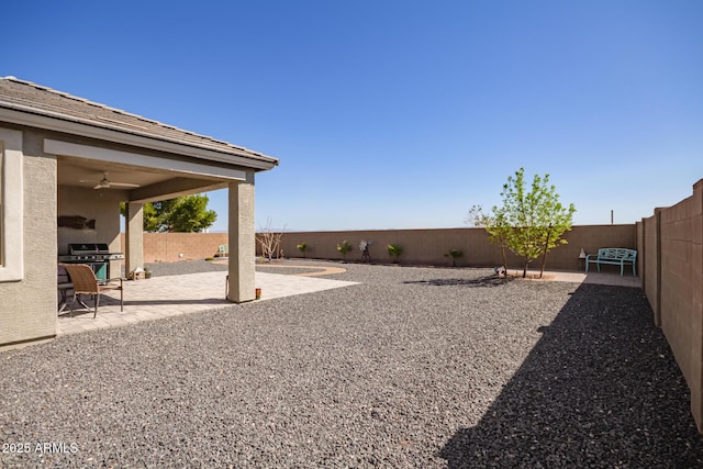 view of yard with a patio, a fenced backyard, and ceiling fan