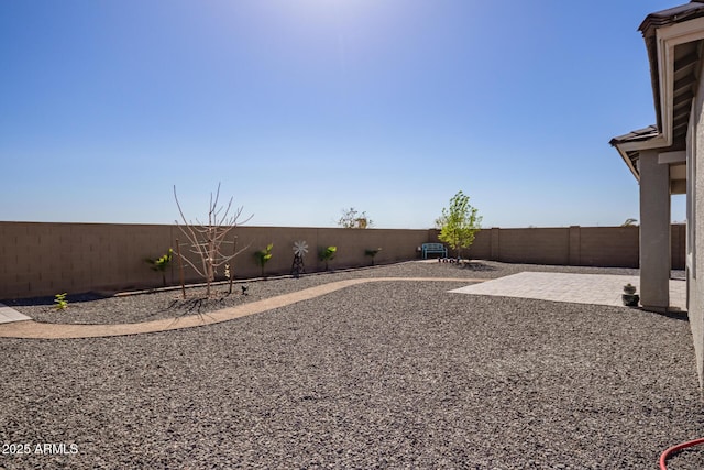 fenced backyard with a patio area