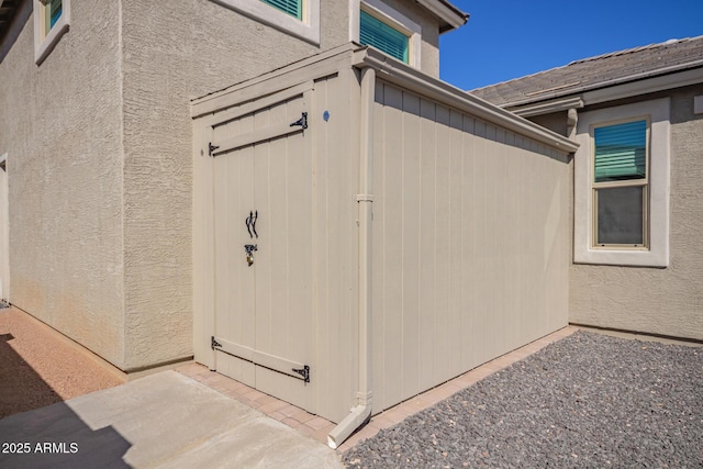 entrance to property featuring stucco siding