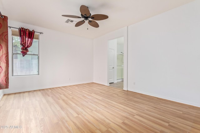 empty room with ceiling fan and light hardwood / wood-style floors