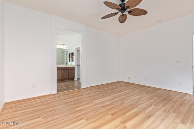 unfurnished room featuring ceiling fan and light hardwood / wood-style flooring