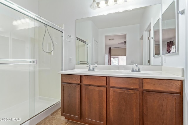 bathroom featuring vanity, a shower with shower door, and tile patterned flooring