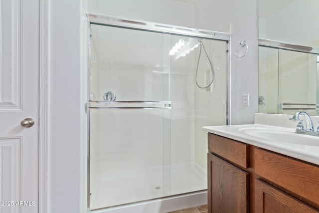 bathroom with an enclosed shower and vanity