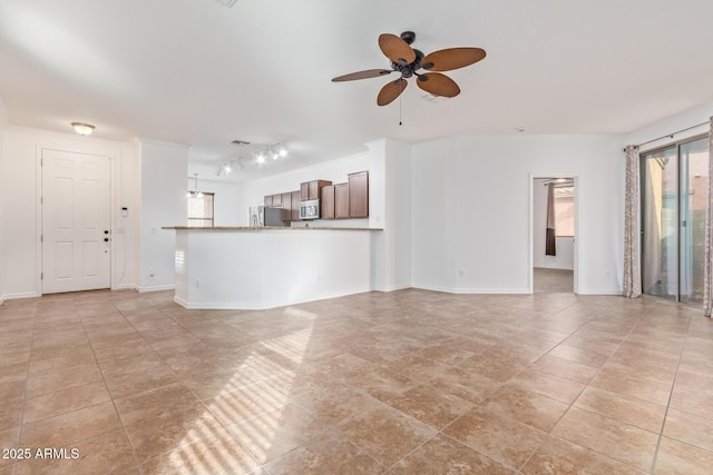 unfurnished living room featuring ceiling fan