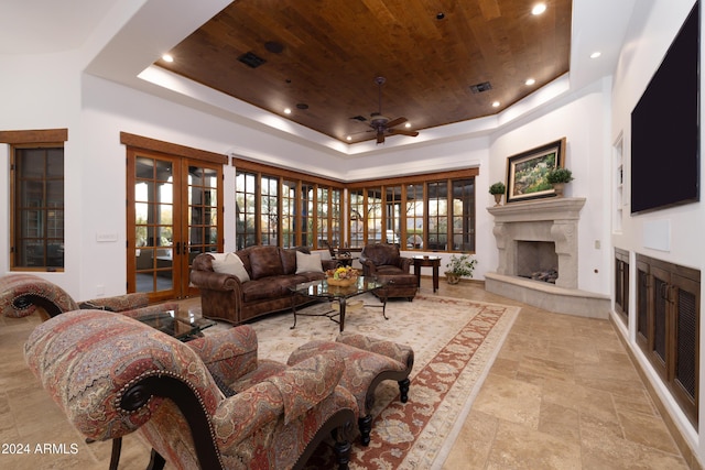 living room featuring french doors, a tray ceiling, ceiling fan, and wooden ceiling