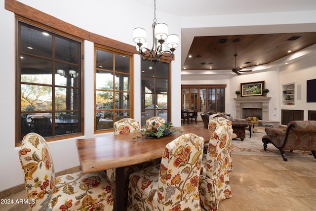 dining room featuring ceiling fan with notable chandelier and wooden ceiling