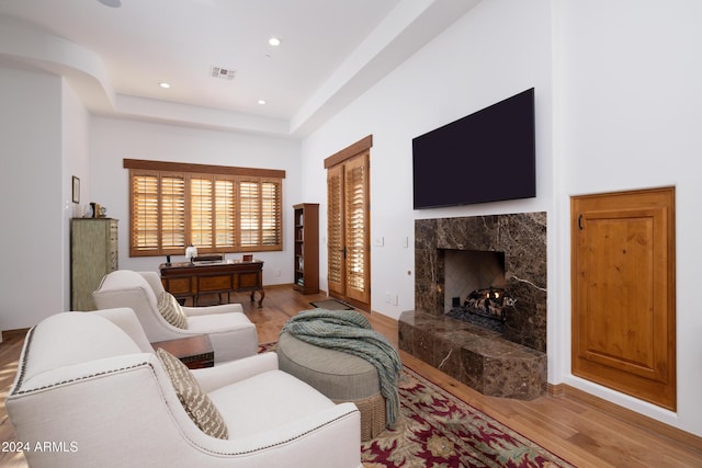 living room with a fireplace and light hardwood / wood-style flooring