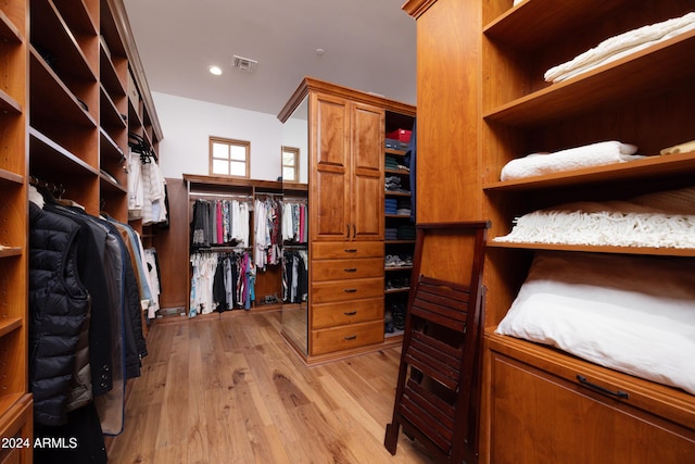 spacious closet with light hardwood / wood-style flooring